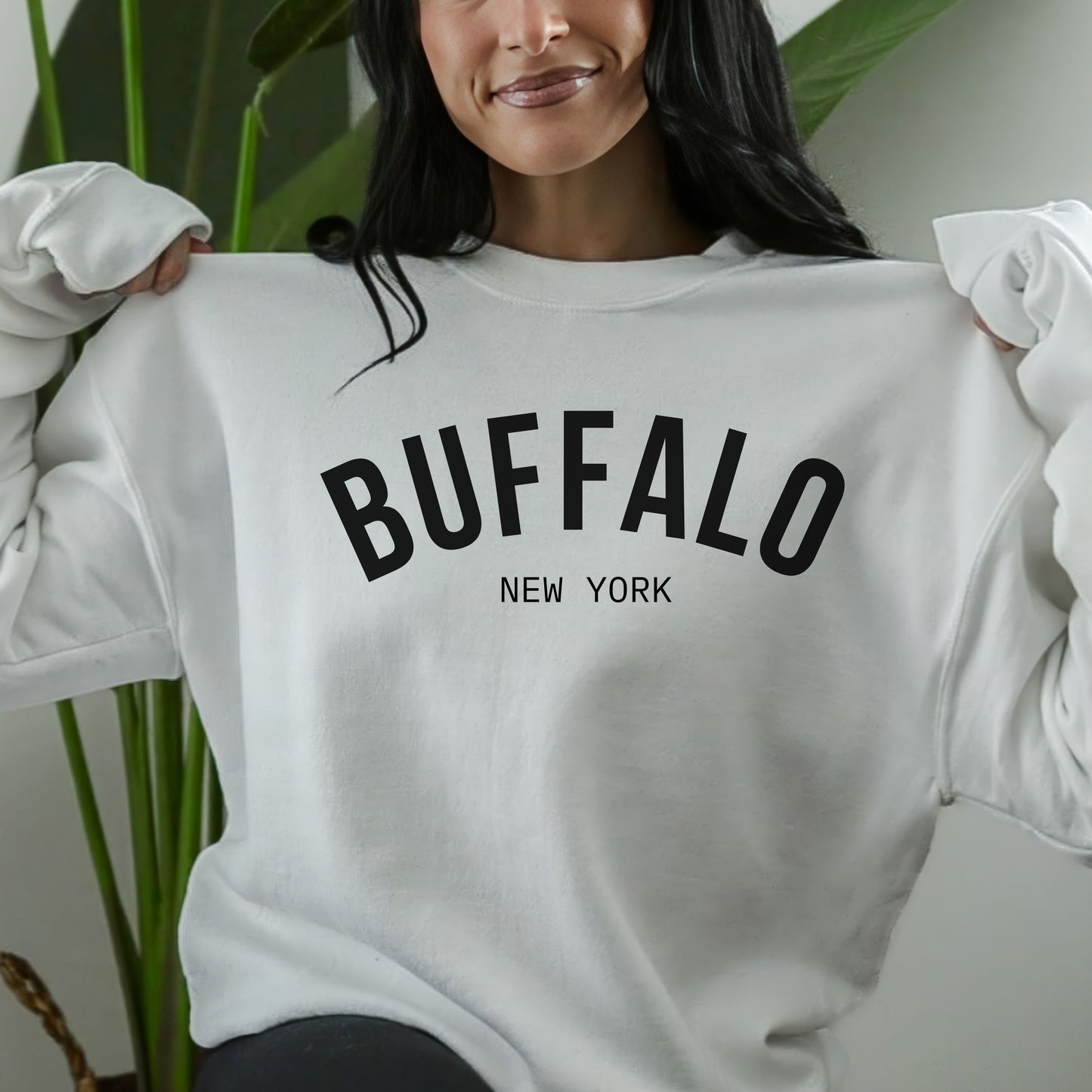 a woman wearing a sweatshirt that says buffalo new york