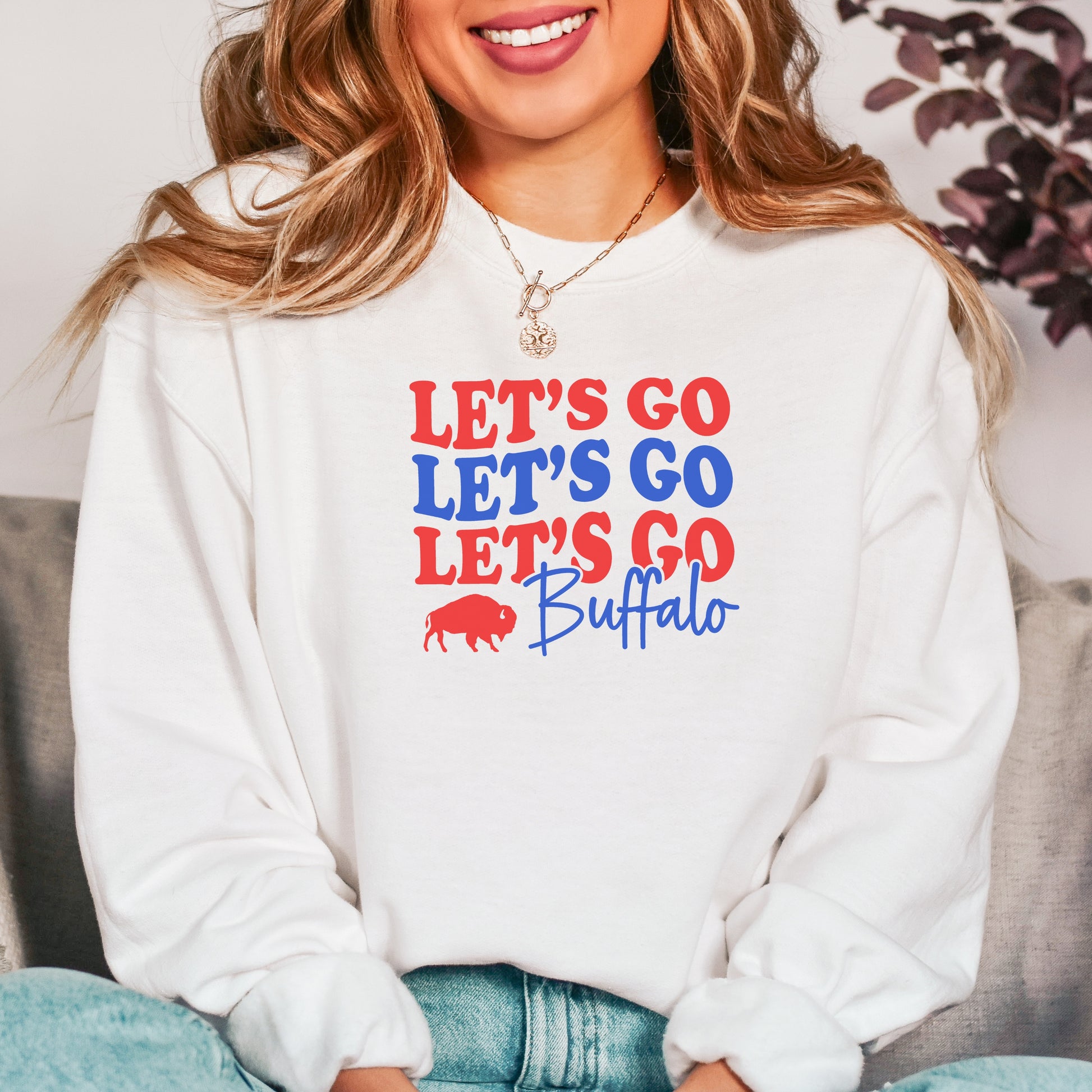 a woman wearing a sweatshirt that says let's go let's go buffalo