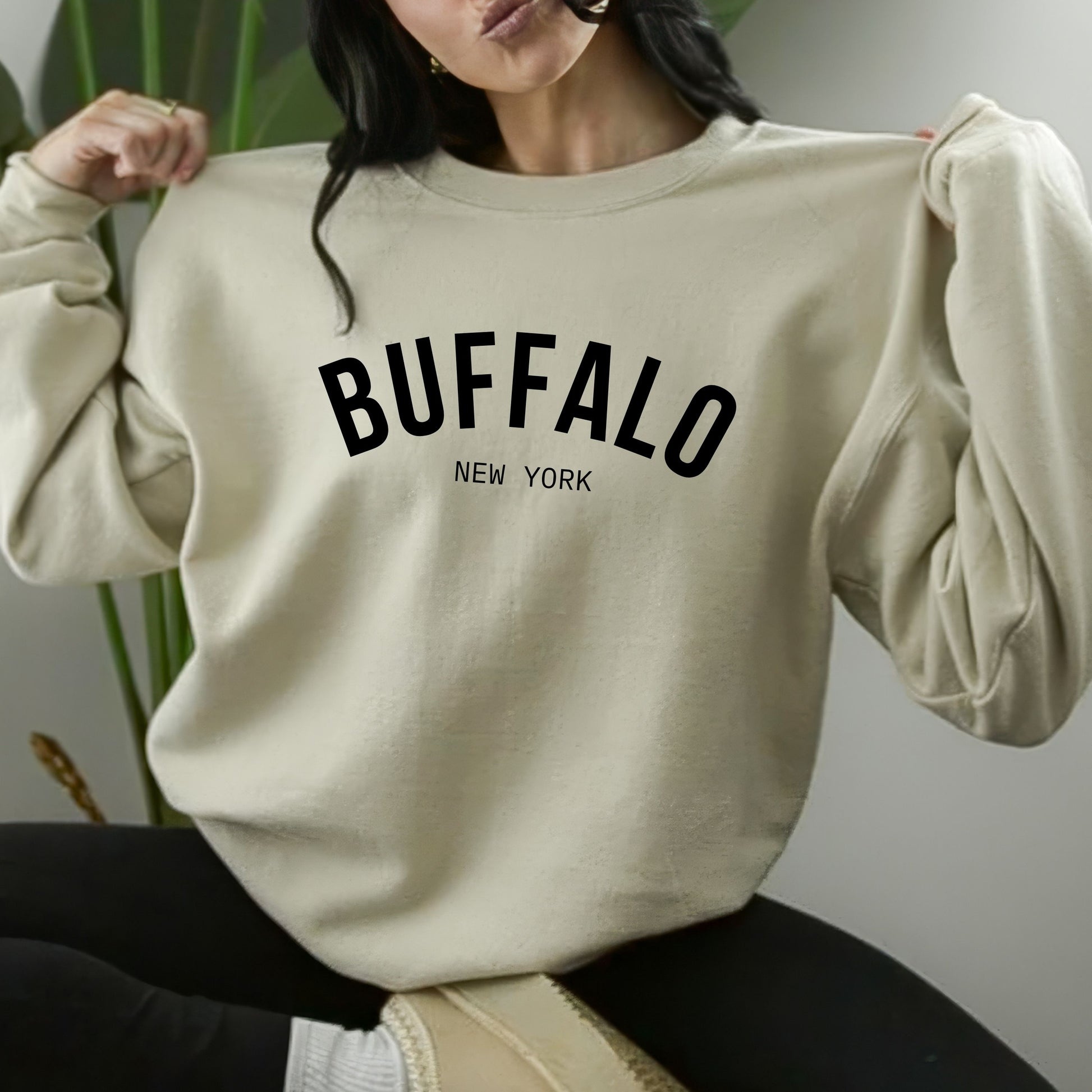 a woman sitting on a chair wearing a sweater