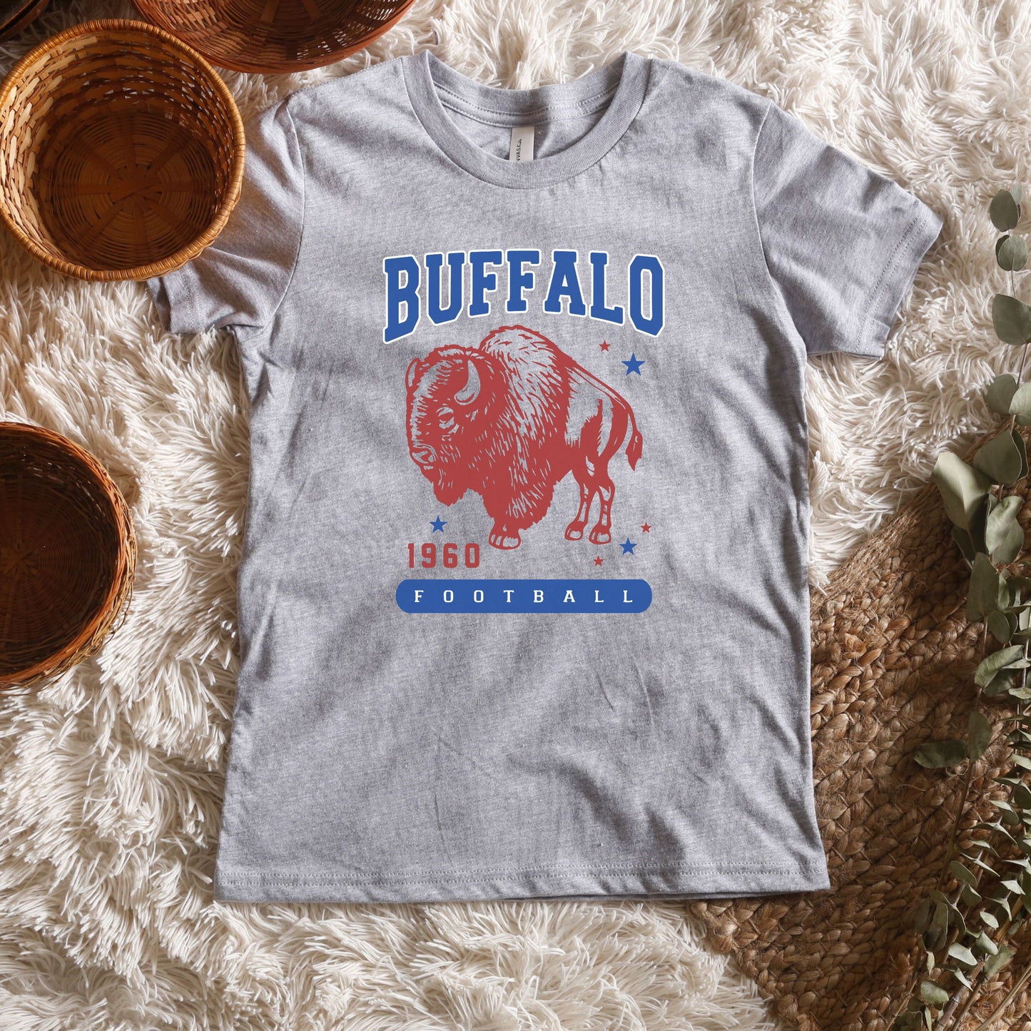 a buffalo football t - shirt sitting on top of a white rug