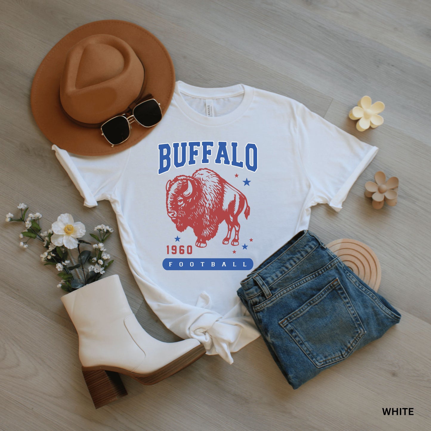 a white shirt with buffalo on it and a cowboy hat next to it