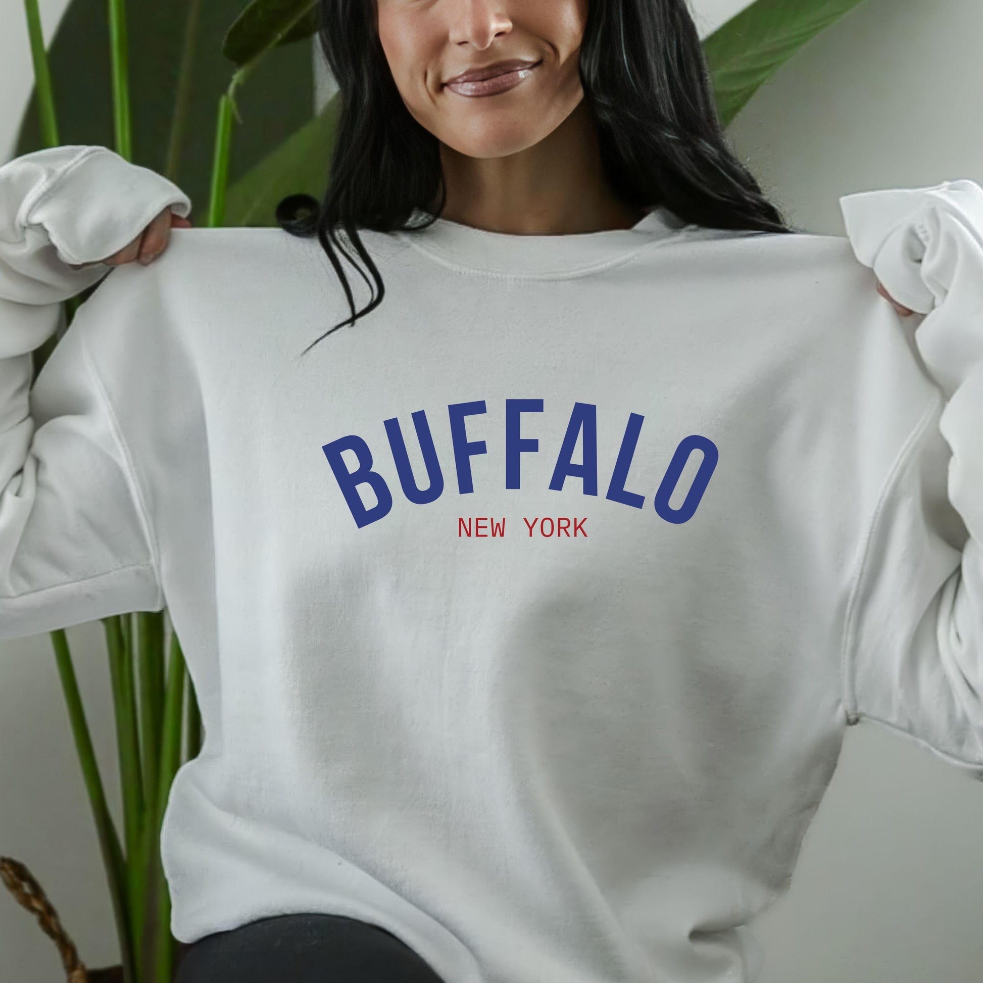 a woman wearing a sweatshirt that says buffalo new york