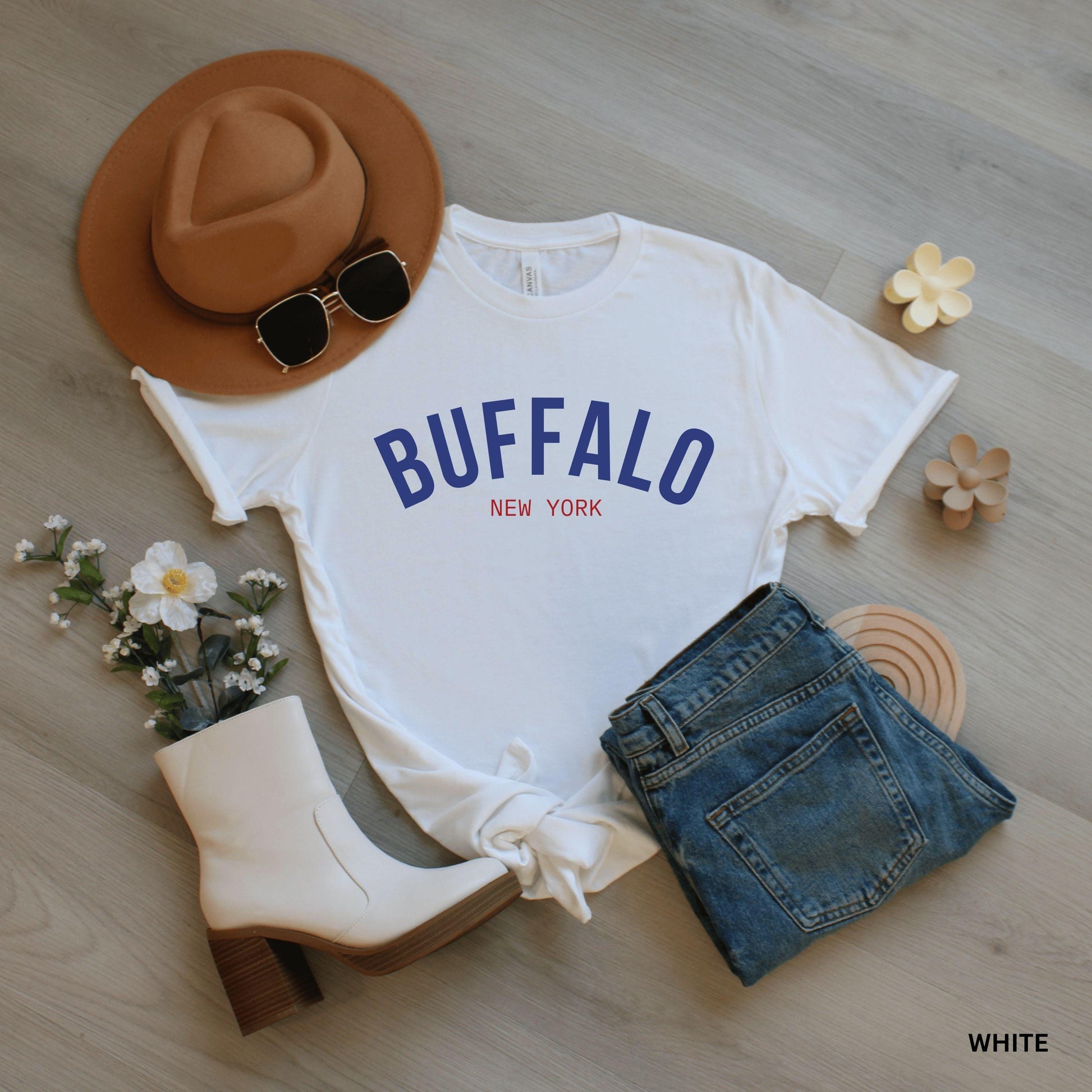 a white shirt that says buffalo next to a pair of jeans and a cowboy hat