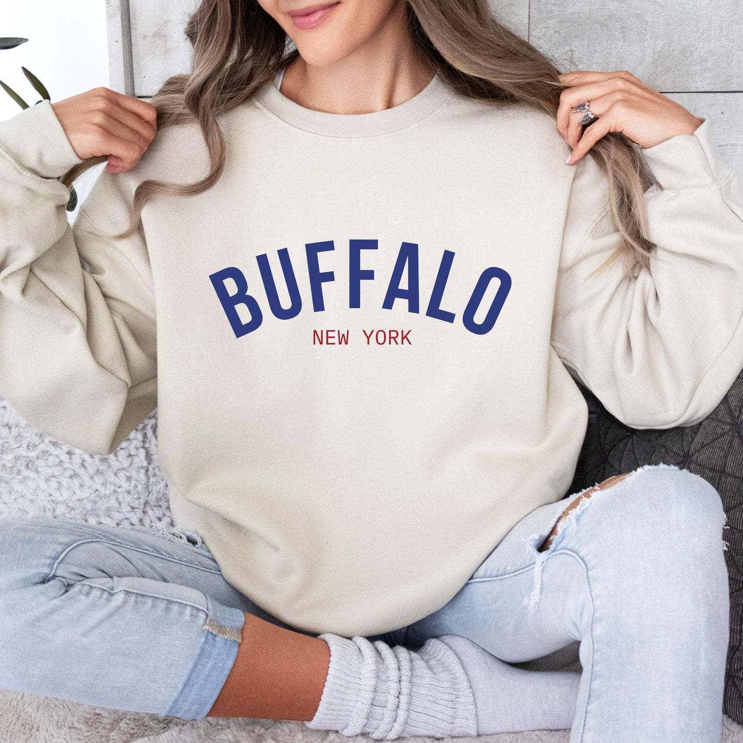 a woman wearing a sweatshirt that says buffalo new york